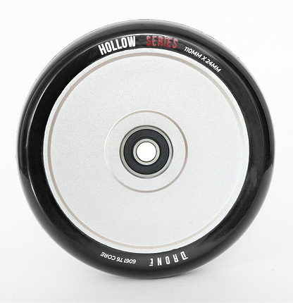 Close-up of the Drone Hollow Series 110mm Stunt Scooter Wheel - Silver, featuring its durable circular design. It has a central hub with a smooth, reflective surface, and its size (110mm x 24mm) is marked on it.
