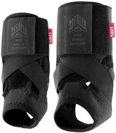 Two GAIN Protection Stealth Pro Junior ankle supports in black, featuring crisscross straps, open heel, and adjustable compression. The left brace has a "STEALTH PRO ANKLE SUPPORT" label; both display a small red tag with white text.