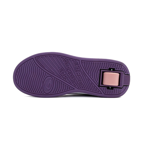 The image displays the purple sole of Breezy Rollers Skater Girls Shoes in white, purple, and pink by Breezy Rollers, featuring textured grip patterns, a circular logo with stylized text, and a pink rectangular section near the heel.