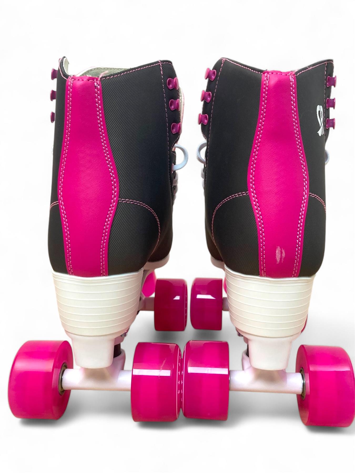 The Supreme Malibu Quad Roller Skates in Black/Pink by Supreme feature white heels and bright pink wheels, shown from the back on a white background—stylish and comfortable skates ideal for outdoor fun.