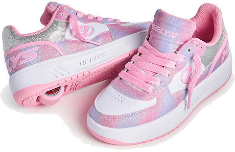 Heelys Rezerve Low Girls Shoes by Heelys, in light pink, white, and rainbow colors with pink laces and a heel wheel, are shown against a white background.