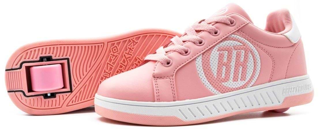 A pair of Breezy Rollers Classic Shoes in pink and white by Breezy Rollers, featuring white soles, laces, a perforated circle on the side, and a patented heel wheel system for smooth rolling wherever you go.