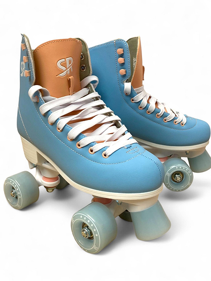 The Supreme Malibu Quad Roller Skates – Light Blue by Supreme feature retro-style light blue and tan boots, white laces, and light blue wheels—ideal beginner skates for recreational use, shown on a plain white background.