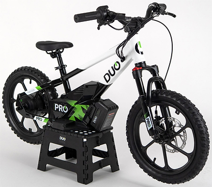 The Duo 16" Master Pro Kids Electric Balance Bike in white and black, featuring thick tires and training wheels, is shown on a black stand against a plain white background.