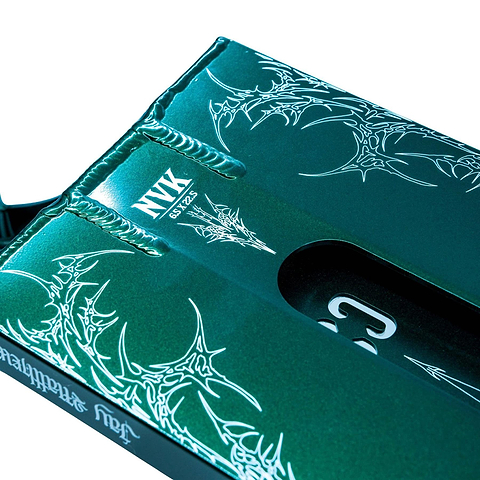 Close-up of the CORE ST3 Forged Green J.Matthews Signature Street Stunt Scooter Deck (6.5" x 22.5"), featuring intricate white graphics and bold "NYX SBYZ2" text, with part of its wide cutout and hardware also visible.