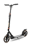 The Frenzy 205mm Dual Brake V4 Foldable Commuter Scooter by Frenzy, features a sleek black design with large wheels and a robust frame. It includes an adjustable handlebar accented with unique gold highlights and a convenient cable folding system. The textured deck provides grip, while the rear brake and kickstand enhance its practicality.