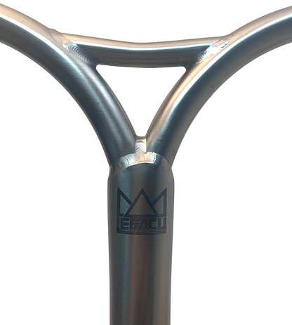 Close-up of Legacy Cut-Out Titanium Oversized HIC Stunt Scooter Y-Bars (660mm x 600mm, Chrome) with visible welds and black Legacy logo—lightweight and ideal for park riders—shown against a white background.