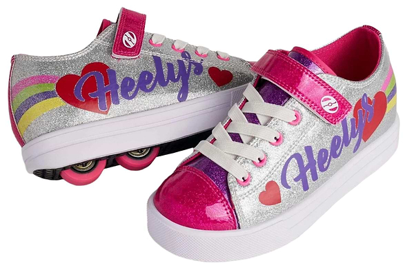 Two Heelys Snazzy X2 Girls Shoes by Heelys in silver with rainbow stripes and pink hearts. Features glittery uppers, pink wheels, "Heelys" in purple, and a versatile design: one shoe shows 2 wheels per shoe while the other lays flat.