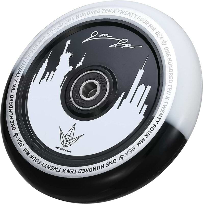 A Blunt Envy 110mm Jon Reyes Signature Hollow Core stunt scooter wheel in black and white showcases a city skyline design with his signature on the rim. Text encircles the edge stating "One Hundred Ten x Twenty Four mm 86A" and "Hollow Core," embodying the essence of Hollowcore Wheels.