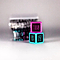 Two vibrant dice from the Trick Dice Advanced Scooter Set, ideal for a trick challenge, are meticulously stacked. The top die is pink and displays "180," while the bottom one is blue and features "BRI FLIP" alongside "KICKLESS." A softly blurred background enhances the focus on these Trick Dice products, evoking the expertise of professional rider Terry Price.