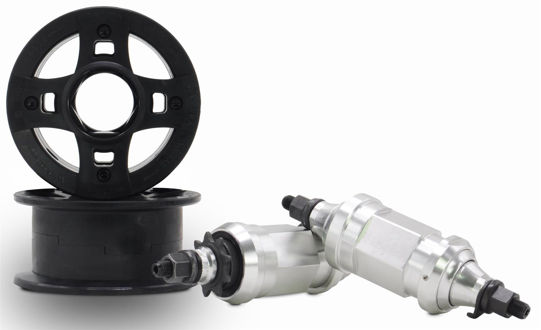 Two black plastic go-kart wheel rims are shown next to two silver kart wheel hubs with bolts on a white background—durable parts like those found on the Wildcat OG 3A Mini BMX Bike - Royal Red Bull by Wildcat. One hub leans at an angle against the other.