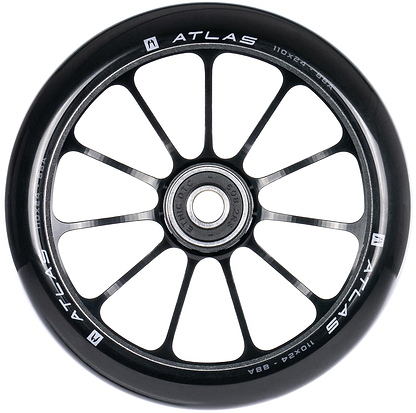 A close-up of the Ethic DTC Atlas 110mm Stunt Scooter Wheel in black, showing its twelve-spoke design, central bearing, and white specs on the rim. This lightweight performance wheel is made by Ethic.