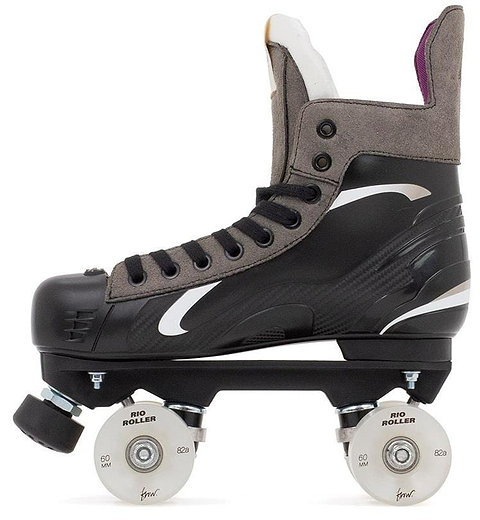 The Rio Roller Flow Hockey Quad Roller Skates in black feature a sleek, aerodynamic design with gray and white accents, sustainable elements, and a high-top boot style for optimal ankle support. They also include white laces and wheels.