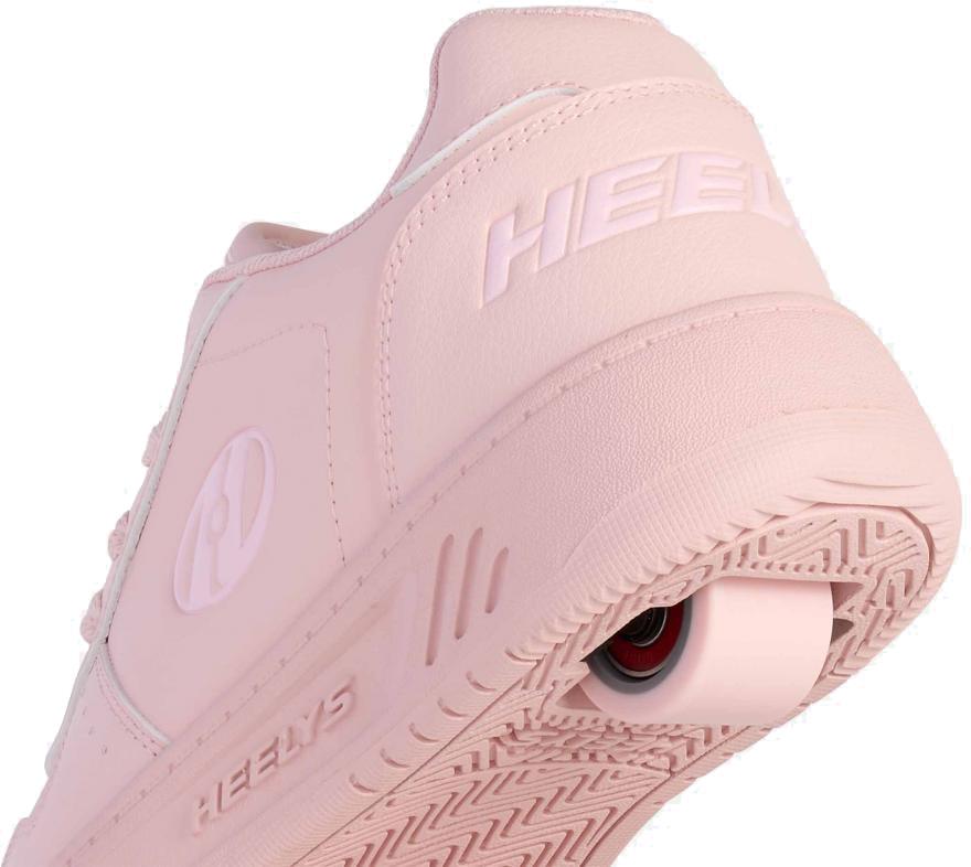 A close-up of Heelys Kama Girls Shoes in pink features the Heelys brand on the heel and signature low-profile wheels in the sole, blending a sleek court-style look with fun rolling action.
