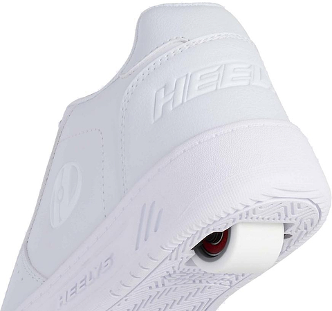 A close-up of Heelys Kama Girls Shoes in white, featuring the Heelys brand embossed on the heel and a single low-profile wheel set into the back of the sole.