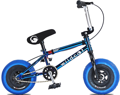 The Wildcat OG 3A Mini BMX Bike - Royal Blue features a blue and black frame, black seat, blue tires, CNC aluminium rims, visible pedals, chain, brake cables, and PRO Street 65PSI tyres. "Wildcat" is printed on the frame.