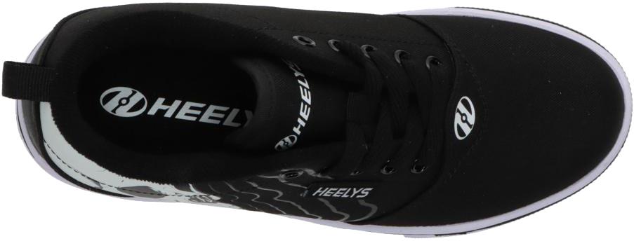Top view of Heelys Pro 20 PRNT Glow Boys Shoes in black/white, featuring black laces, a white logo on the insole and tongue, low-profile wheels, and a white sole by Heelys.
