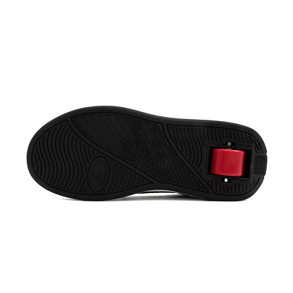 The image shows the black rubber sole of Breezy Rollers Groovy Shoes - Cartoon, featuring a red rectangular wheel near the heel that highlights its patented wheel system for both rolling and walking.