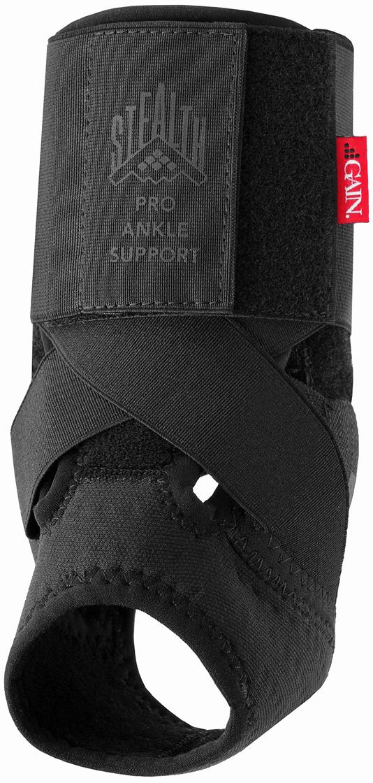 Black GAIN Stealth Pro Junior Ankle Support features crisscross straps, adjustable compression, and an open heel. A red "GENU" tag is on the side, offering optimal ankle protection under the GAIN brand.