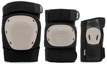 The REKD Shield Triple Skate Protection Pad Set in Black/Beige includes a knee pad and elbow pad with beige hard shells, plus a wrist guard with a high-impact palm splint—all offering premium action sports protection and featuring the REKD logo.
