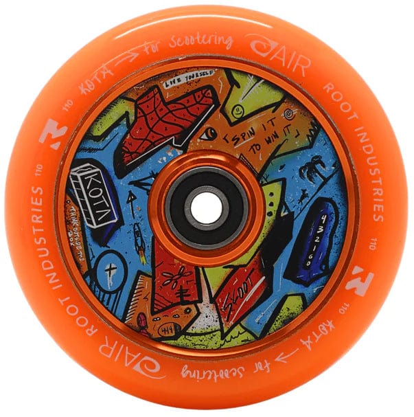 The Root Industries x KOTA Limited Edition AIR 110mm Stunt Scooter Wheel in orange features colorful abstract artwork with faces and patterns on the inner core, centered around a black bearing.