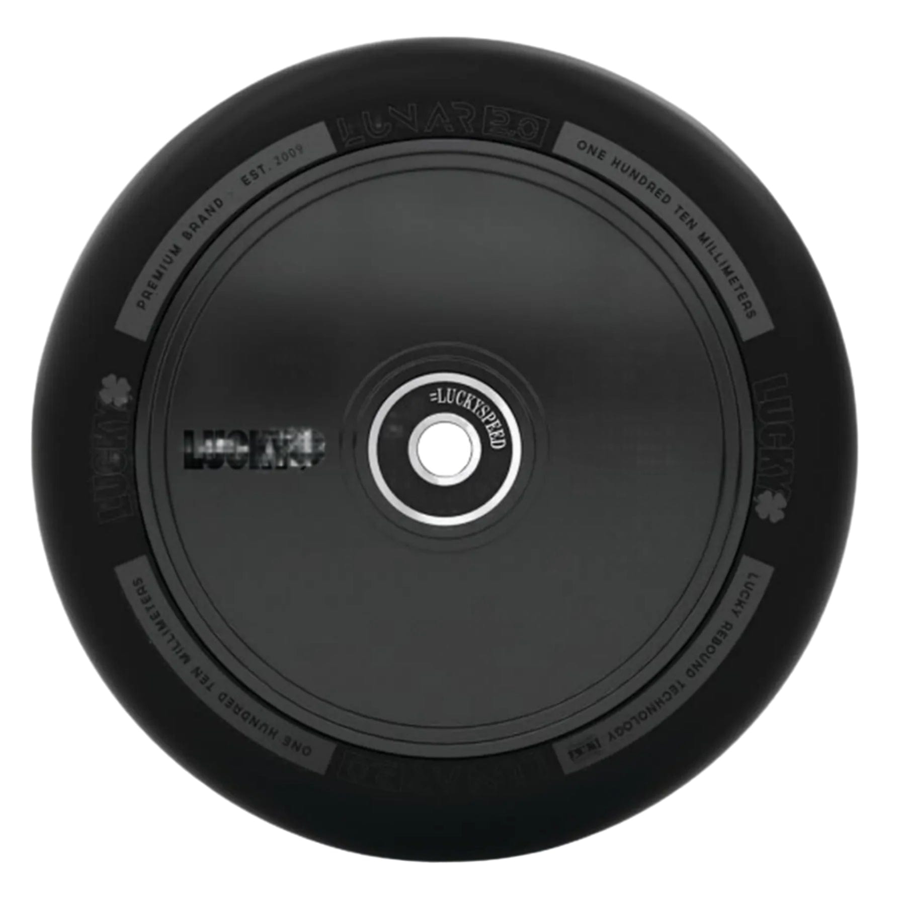 The Lucky Lunar 110mm Stunt Scooter Wheel - Shadow features a sleek black design with subtle decorations from above, showcasing "Lucky" branding and specs around its rim. Its circular metal core highlights the outstanding craftsmanship of Lucky Rebound Technology.