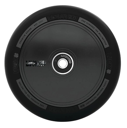 The Lucky Lunar 110mm Stunt Scooter Wheel - Shadow features a sleek black design with subtle decorations from above, showcasing "Lucky" branding and specs around its rim. Its circular metal core highlights the outstanding craftsmanship of Lucky Rebound Technology.