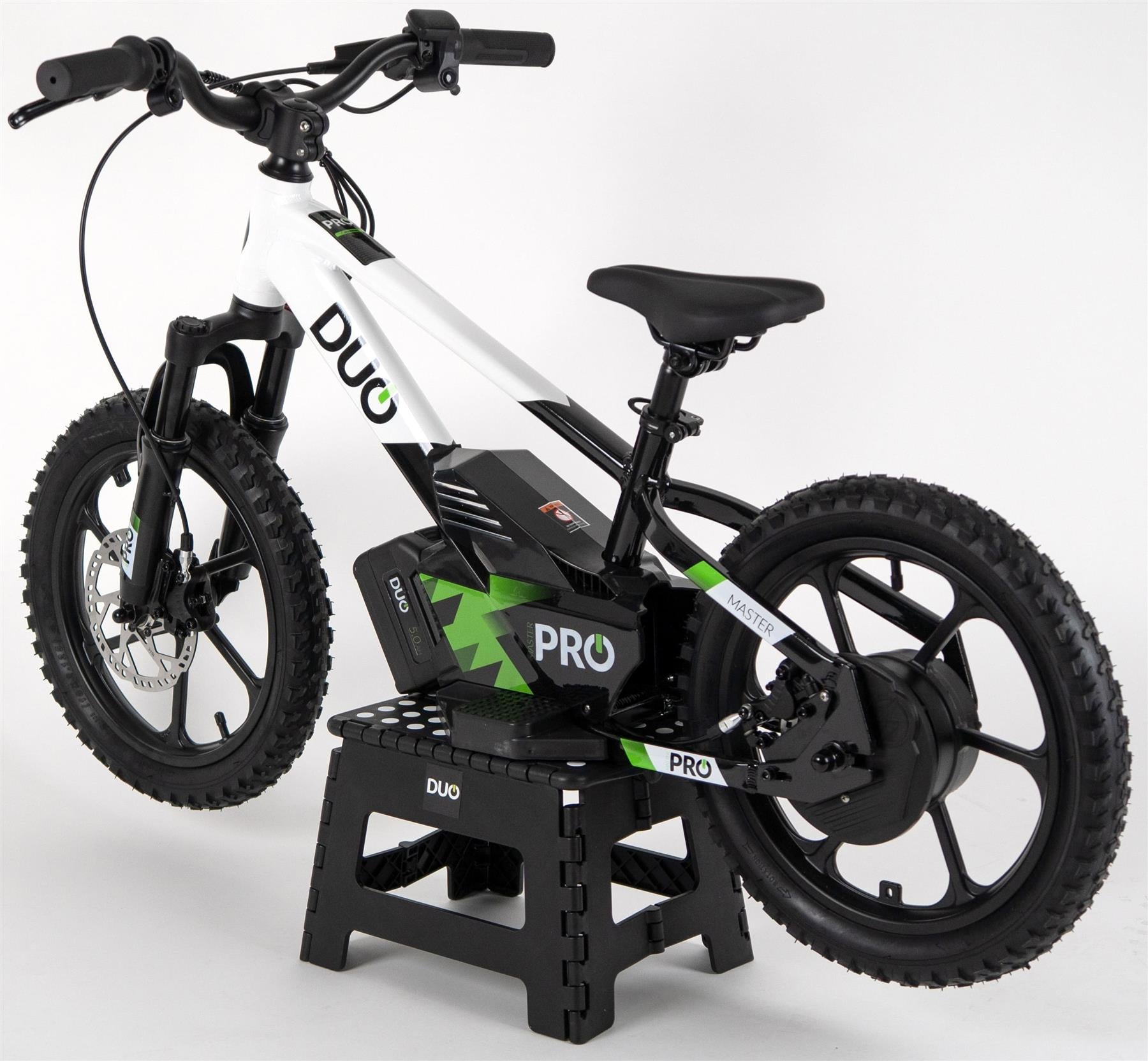 The Duo 16" Master Pro Kids Electric Balance Bike in white and black is shown on a black stand against a white background. This sturdy bike features thick tires, bold “DUO” branding, and is designed for kids.