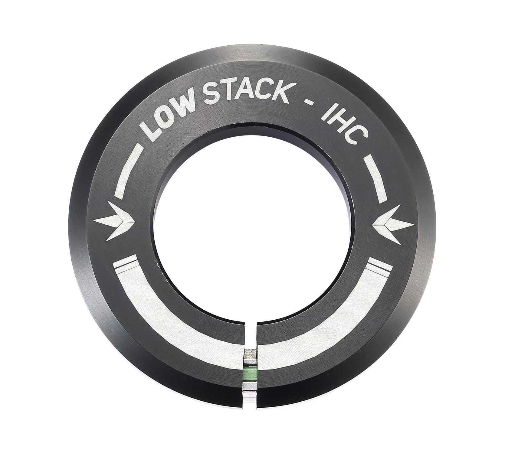 The Blunt Envy Low Stack IHC Integrated Stunt Scooter Headset - Black features a black circular metal ring with a split at the bottom, part of the IHC compression system. It is engraved with "LOW STACK - IHC" alongside two inward-pointing arrows, ensuring compatibility with sealed bearings for a smooth ride.
