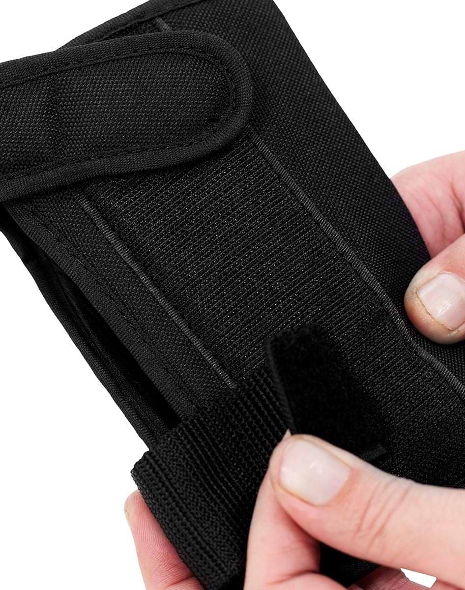 A close-up of hands opening the Velcro strap on a REKD Shield Triple Skate Protection Pad Set in Black / Beige, showcasing durable materials and secure fastening—perfect for storing your REKD action sport pads.