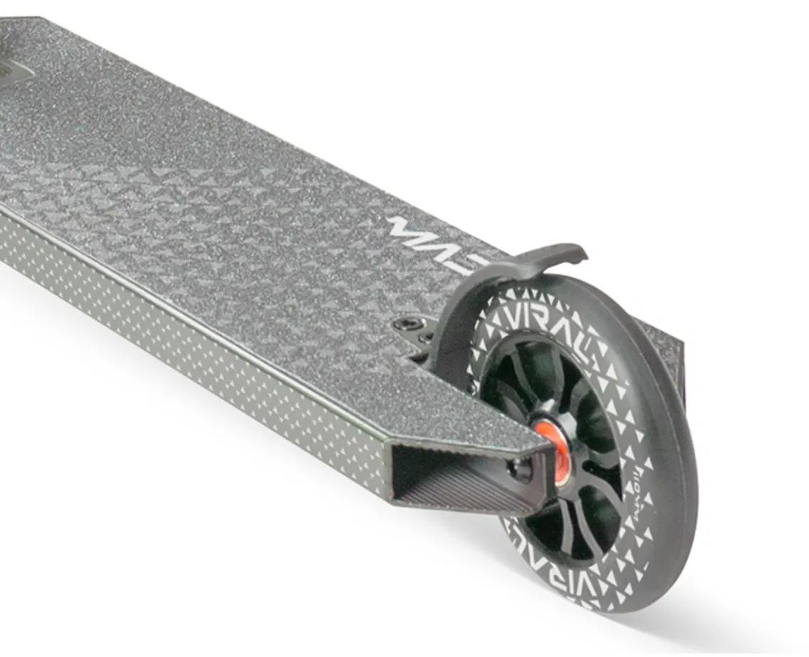 Close-up of the Madd Gear Viral KAOS Complete Stunt Scooter - Forest deck shows the textured grip, black wheel with white pattern, and red accents near the axle—ideal for stunt progression.