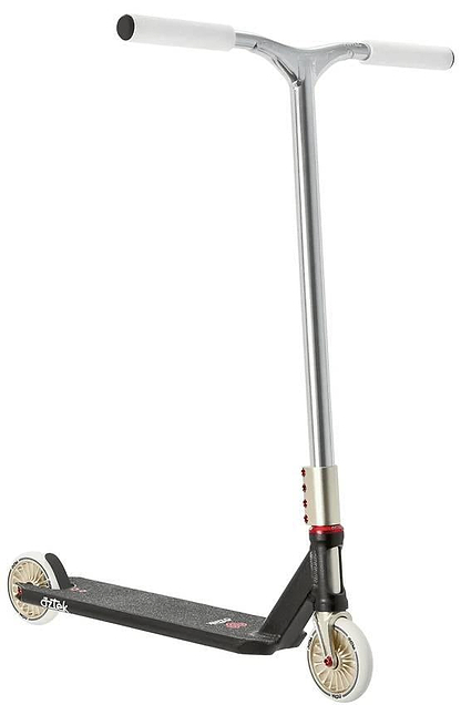 The Aztek Corsa Complete Stunt Scooter in black features silver and black styling, white handlebar grips, small cream wheels, a lightweight design, textured foot deck, and bold red accents near the front wheel. Shown against a white background.