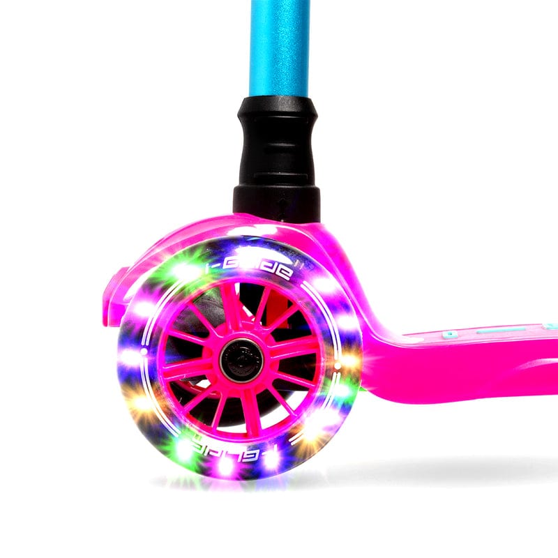 A close-up of a vibrant LED wheel from the i-Glide 3-Wheel LED Kids Scooter - Pink/Aqua showcases its bright colors. The wheel, connected to the scooter's pink frame with an adjustable handlebar, emits a dazzling rainbow glow against the white background.