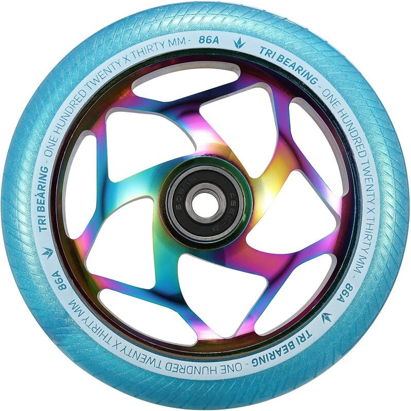 A close-up of the Blunt Envy Tri-Bearing 120mm x 30mm scooter wheel showcases a vibrant neochrome metal core with a light blue tire. The words "Tri Bearing" and "86A" are printed along the inner rim, emphasizing its tri-bearing design for enhanced control.