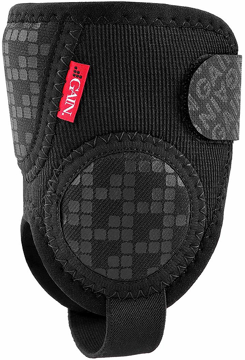 The GAIN Protection Pro Junior Ankle Protectors in black feature a padded design, red label, textured circular grip area, and an adjustable hook-and-loop strap for a secure fit and enhanced impact protection.