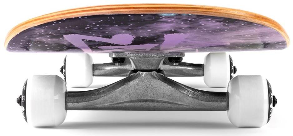 A low-angle view of the Enuff Skully Hologram Black Mini Complete Skateboard features silver trucks, white wheels, and a 7.25" x 29.5" 7-ply maple deck with a space-themed purple and black design.