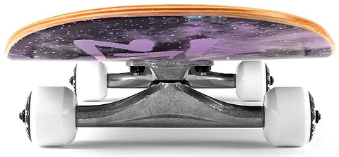 A low-angle view of the Enuff Skully Hologram Black Mini Complete Skateboard features silver trucks, white wheels, and a 7.25" x 29.5" 7-ply maple deck with a space-themed purple and black design.