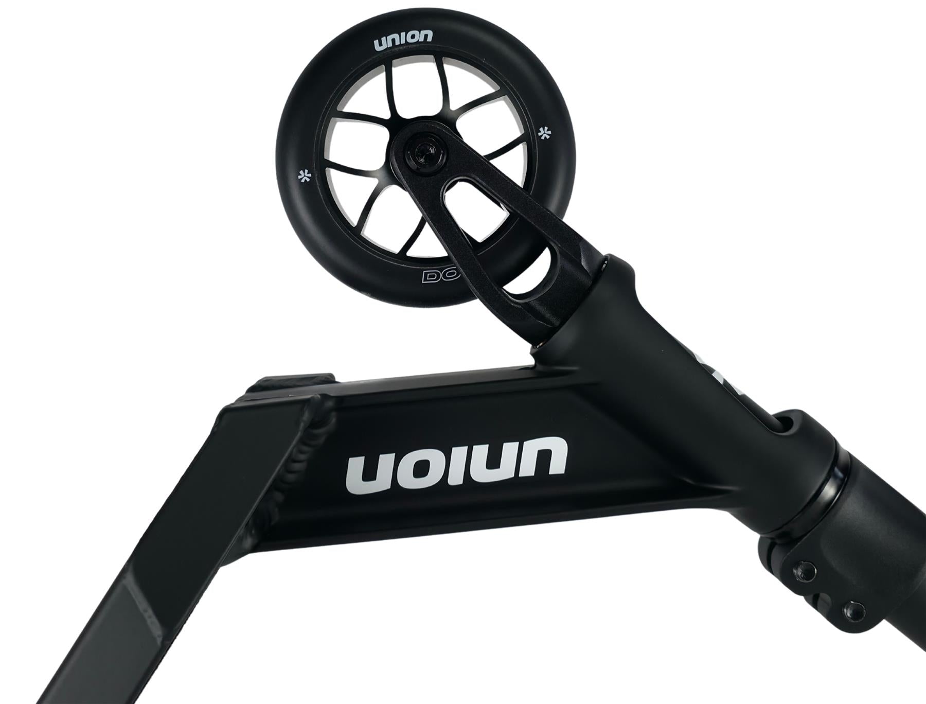 Close-up of the Union Dot Complete Stunt Scooter - Black, showing the front wheel and deck with the "Union" brand name printed in white, upside down on the side.