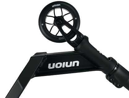 Close-up of the Union Dot Complete Stunt Scooter - Black, showing the front wheel and deck with the "Union" brand name printed in white, upside down on the side.