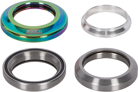 Four individual pieces of a Legacy Velo Integrated Stunt Scooter Headset - Neochrome, including a metallic neochrome top cap, a silver crown race, and two sealed bearing steel cartridges.