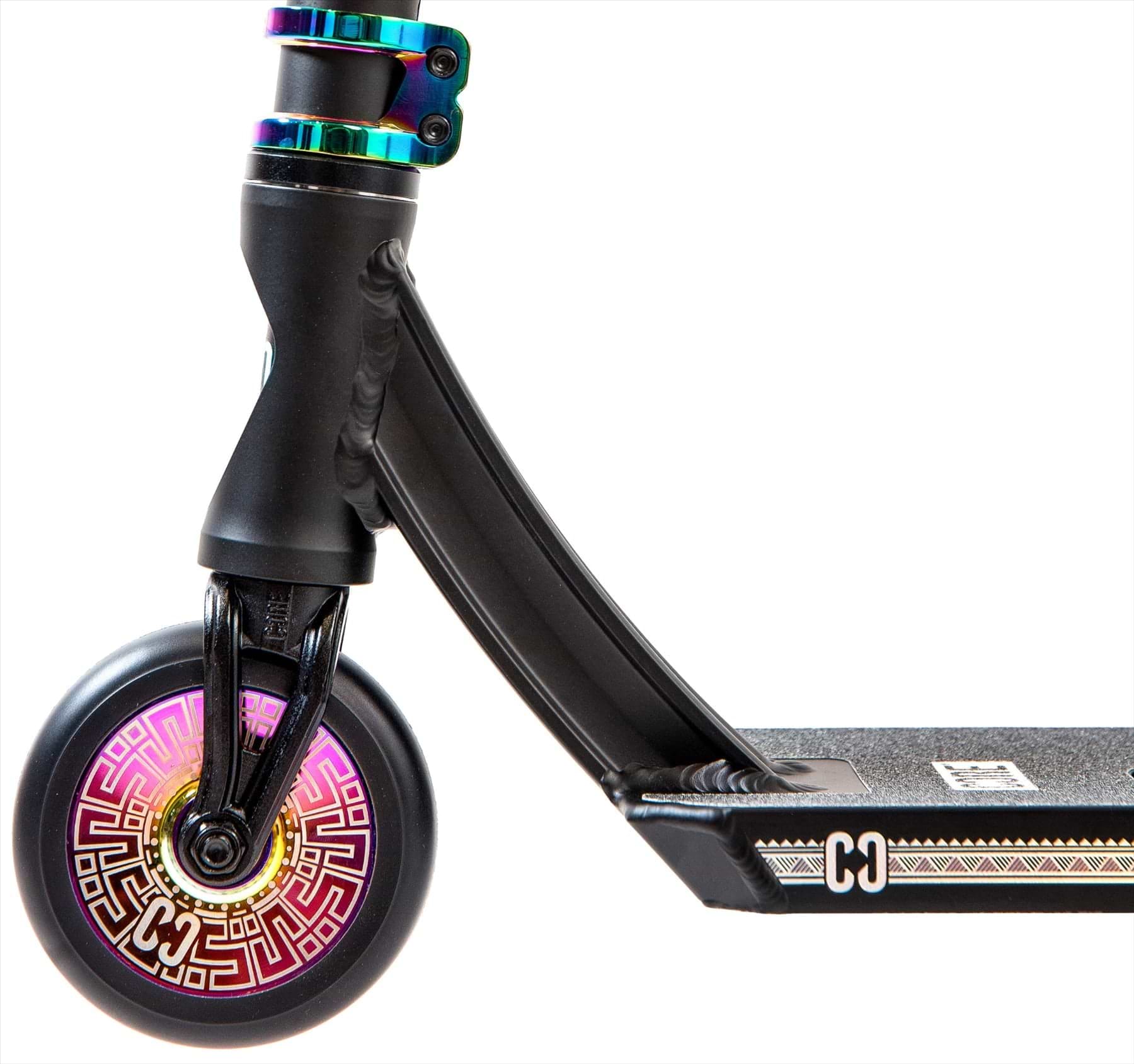 Close-up of the CORE CL1 Complete Stunt Scooter – Black / Neochrome LE by CORE, showing a vibrant front wheel with pink and gold geometric patterns and a black grip deck highlighted with white and gold accents.