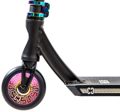 Close-up of the CORE CL1 Complete Stunt Scooter – Black / Neochrome LE by CORE, showing a vibrant front wheel with pink and gold geometric patterns and a black grip deck highlighted with white and gold accents.