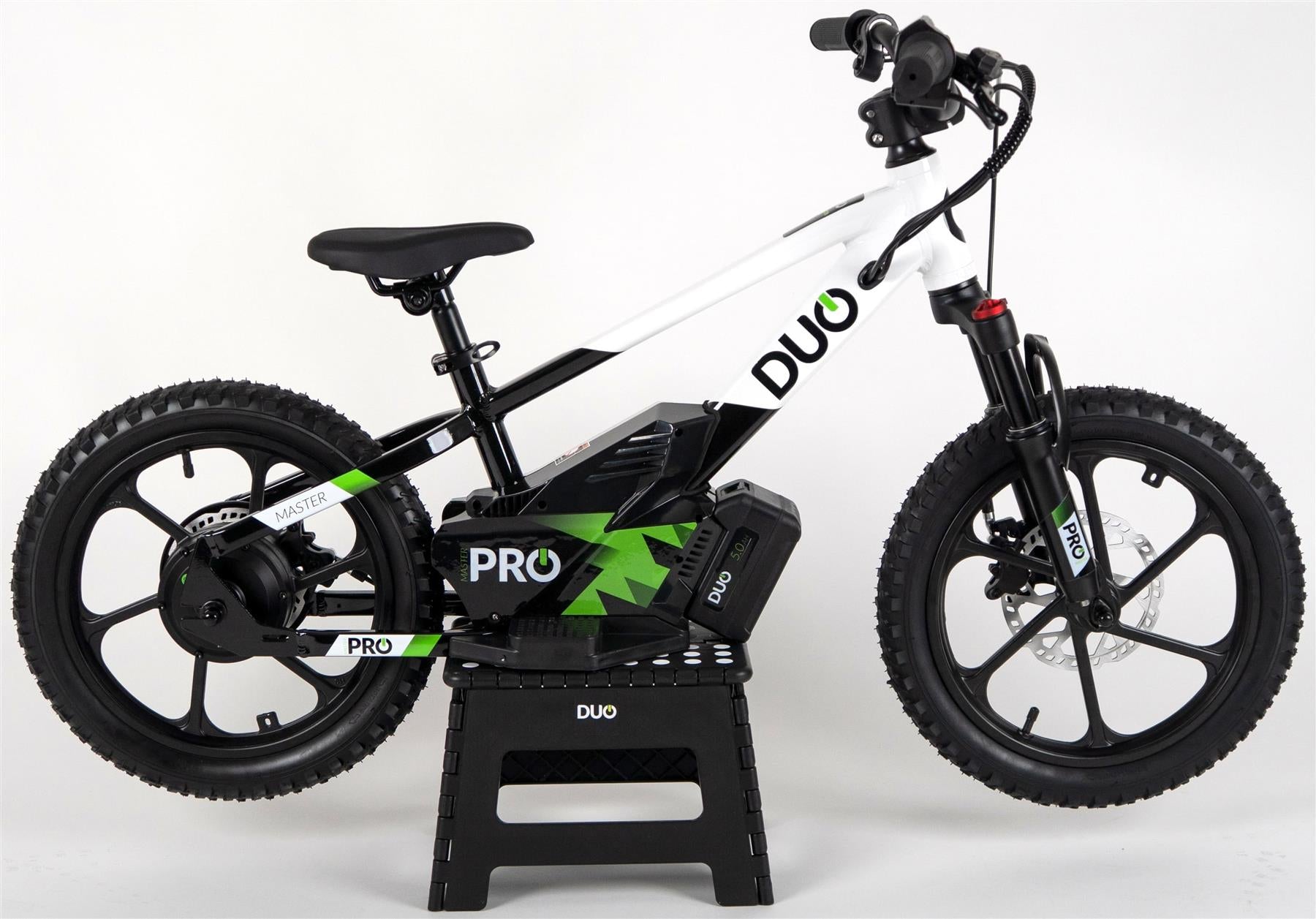 The Duo 16" Master Pro Kids Electric Balance Bike by Duo, in white and black with green accents, is shown on a black stand against a plain white background. It features thick tires and a sturdy frame, perfect for kids.