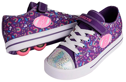A pair of Heelys Snazzy X2 Girls Shoes by Heelys in Purple / Multi / Rainbow, featuring two wheels per shoe, white soles, glittery toes, white laces, and vibrant rainbow patterns displayed from multiple angles.