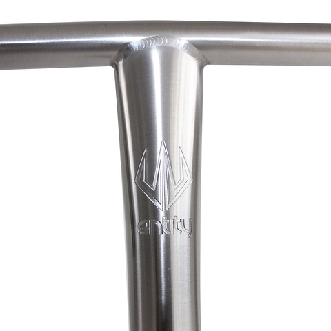 Close-up of a silver, metallic T-shaped scooter handlebar with the "Entity" logo etched on the vertical part. These Entity 9T Titanium Oversized SCS Stunt Scooter T-Bars, crafted from Grade 9 titanium and measuring 680mm x 610mm, boast a smooth and reflective surface ideal for any Titanium Stunt Scooter enthusiast.