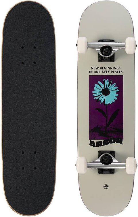 Two skateboards: one features black grip tape, the other is the Arbor Street Revert Daisy Mini Complete Skateboard - 7.5″ x 28.5″ with a blue flower graphic and “New Beginnings in Unlikely Places” on sustainable Canadian maple.