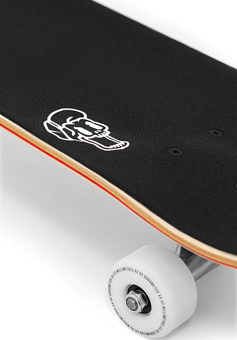 An Enuff Skully Blue Complete Skateboard - 7.75″ x 31.5″ with black grip tape featuring a white skull icon near the tail and one white wheel visible.