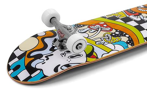 The Enuff Meltworld Mini Confused Complete Skateboard (7.25" x 29.5") by Enuff features colorful, psychedelic artwork with mushrooms, rainbows, abstract shapes, and a face on a checkered background. It comes with white wheels and silver trucks.