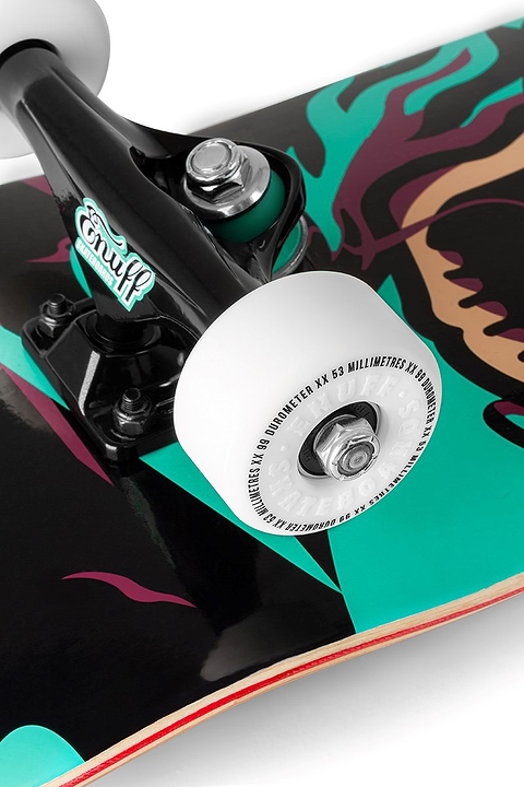Close-up of the Enuff Pyro III Blue Complete Skateboard - 7.75" x 31.5" showing wheel and truck on a 7-ply maple deck with striking black, teal, and magenta graphics; ideal for entry-level riders wanting style and durability from Enuff.