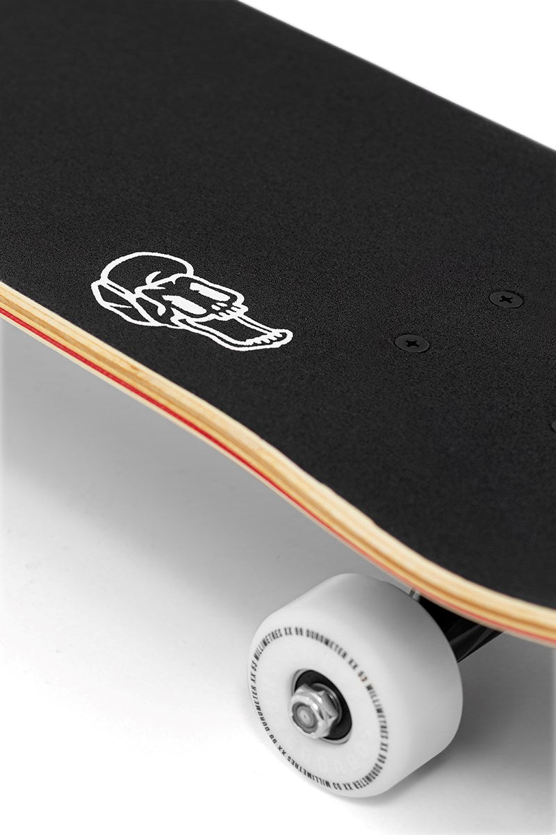 Close-up of the Enuff Pyro III Red Complete Skateboard (7.75" x 31.5") by Enuff, featuring black grip tape, a white skull outline graphic, durable 7-ply maple deck, white wheels with metal trucks—ideal for beginners.